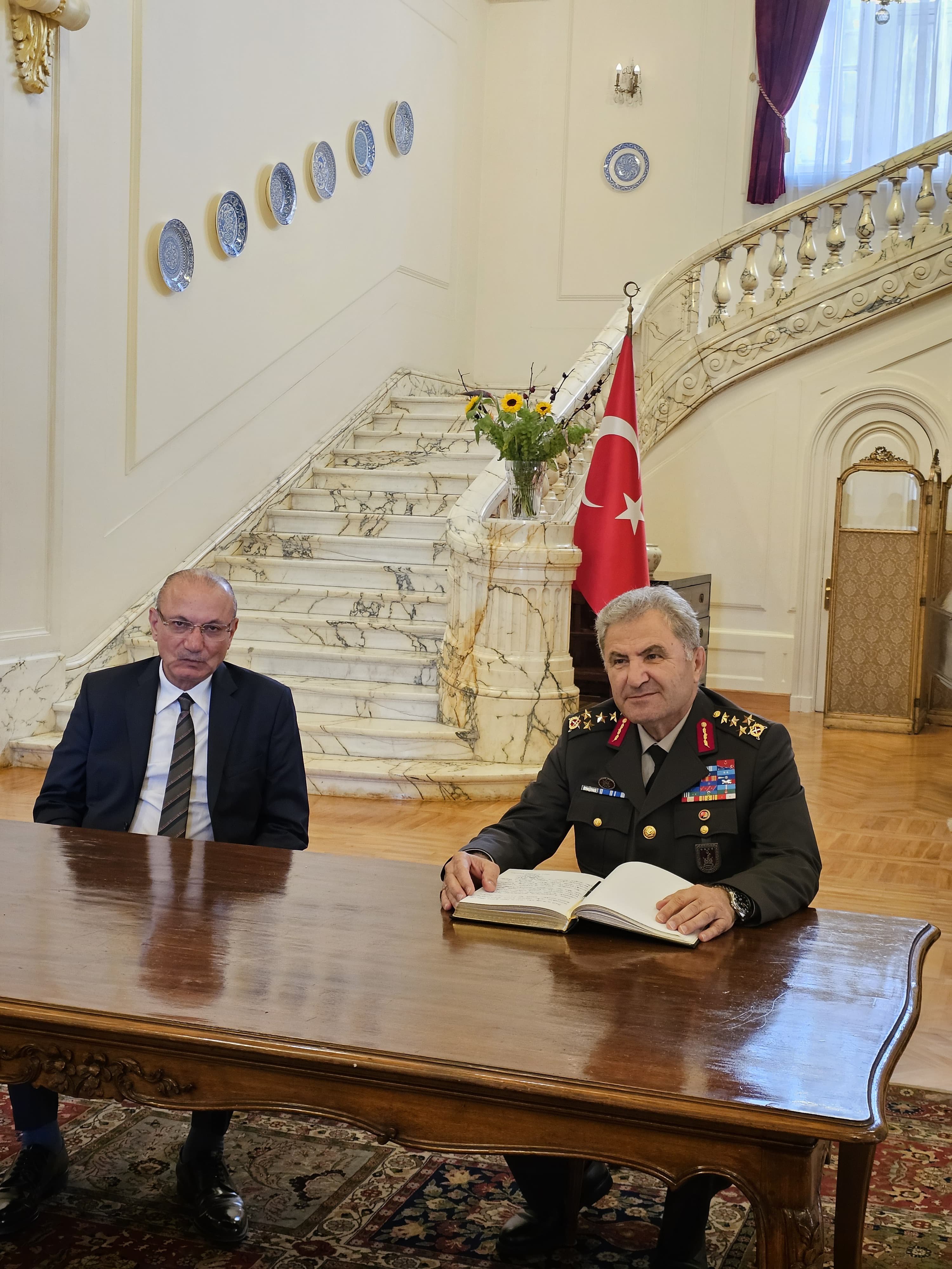 Tokel signing the guestbook