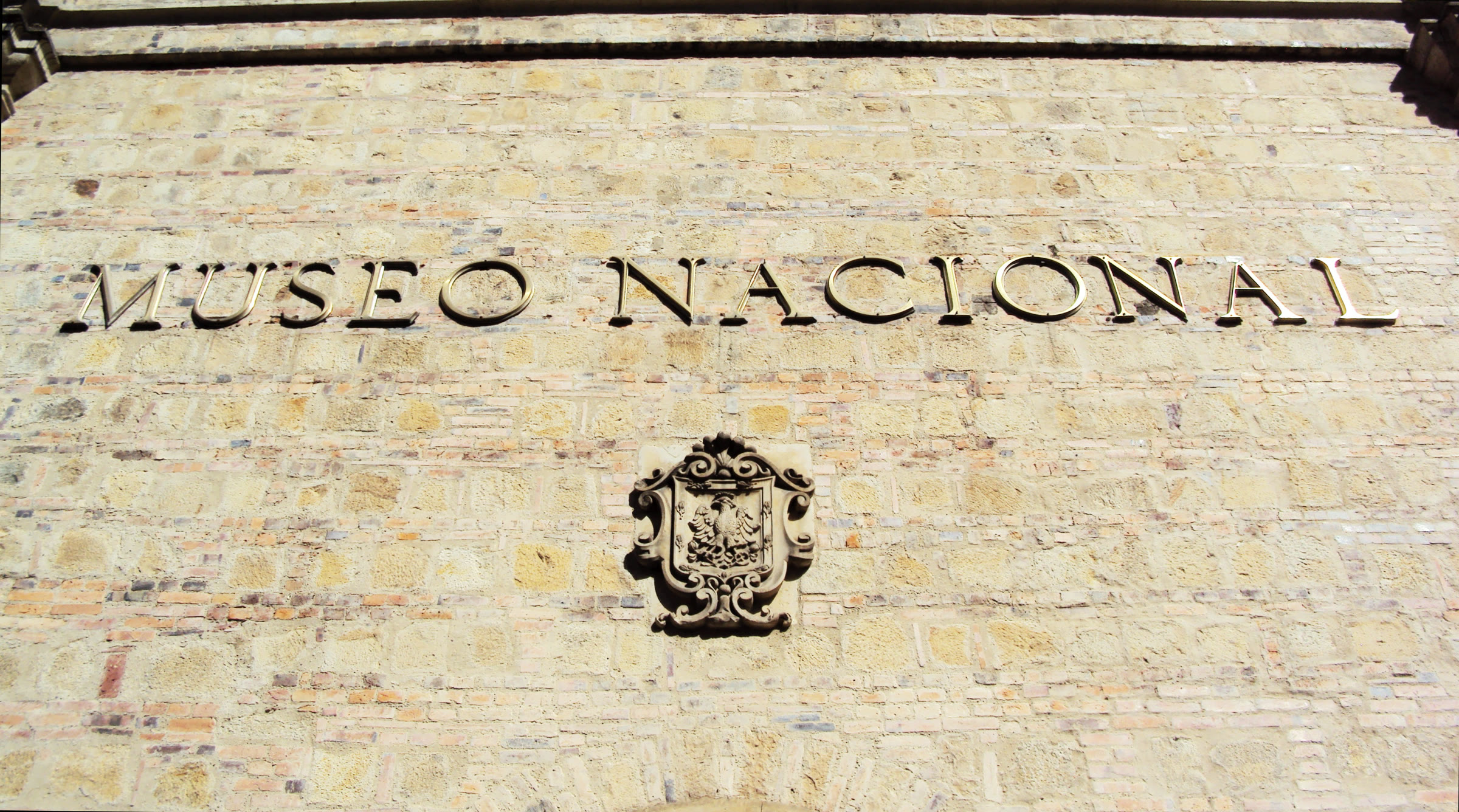 The name and coat of arms above the entrance of the National Museum in Bogotá